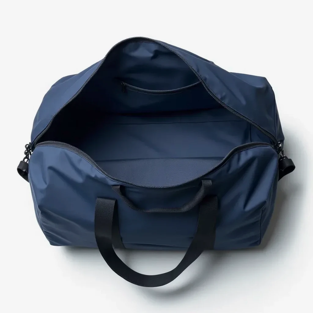 Duffel bag opened and laid flat, revealing the interior mesh ventilation pocket and compartments for a cleaning and upkeep demonstration